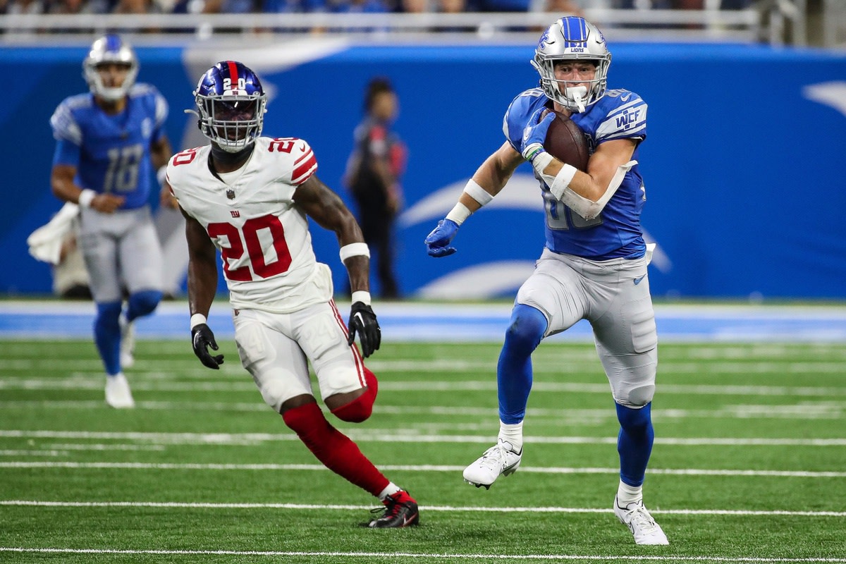 Detroit Lions wide receiver Chase Cota (88) runs after a catch against New York Giants cornerback Amani Oruwariye (20) during the second half of a preseason game at Ford Field in Detroit on Friday, Aug. 11, 2023.