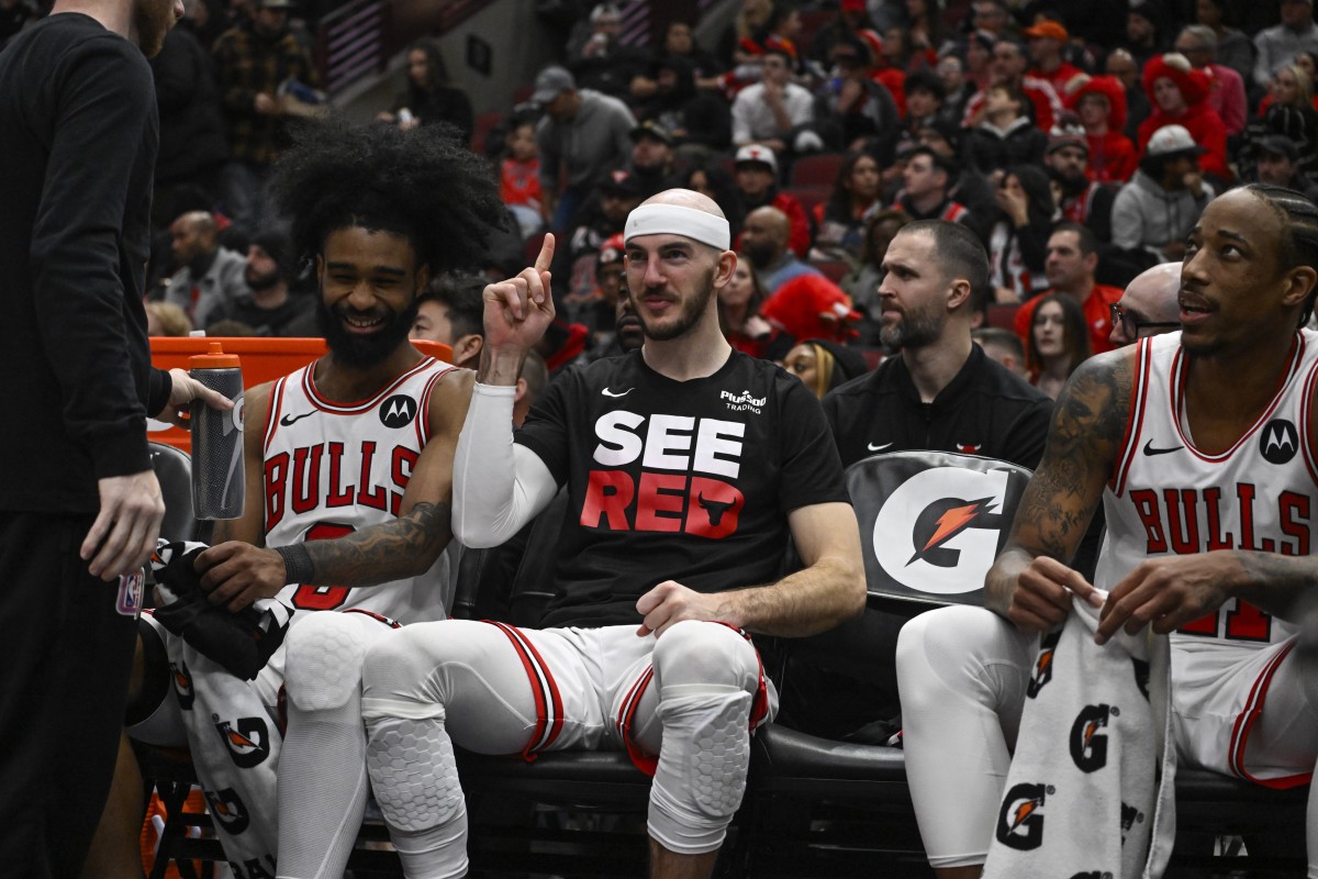 Chicago Bulls guard Coby White (0), guard Alex Caruso (6) and forward DeMar DeRozan (11) laugh on the bench against the Memphis Grizzlies during the second half at the United Center. 