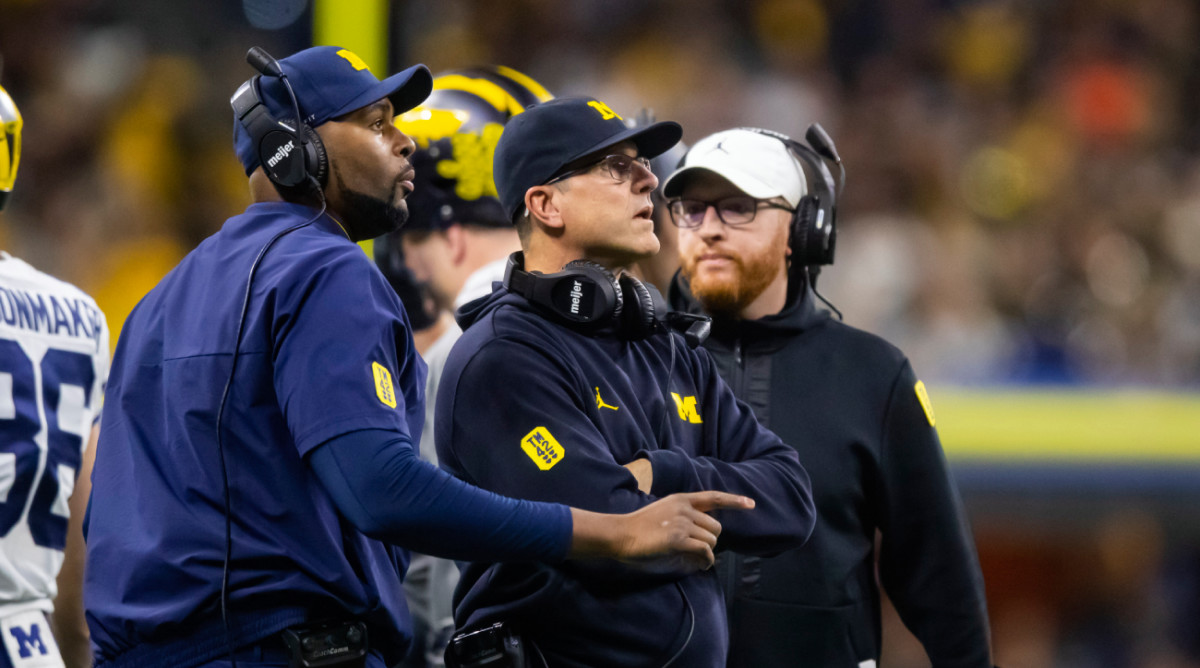 Michigan offensive coordinator Sherrone Moore and coach Jim Harbaugh during a 2021 game.