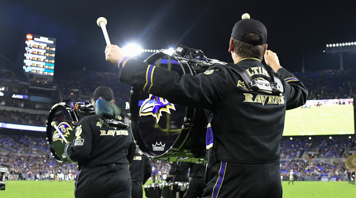 Baltimore Ravens marching band run on the field during a game
