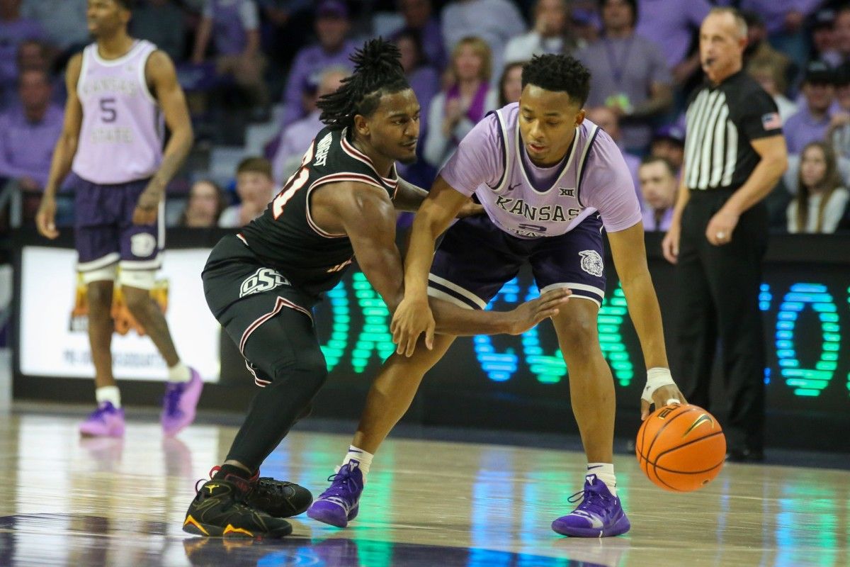 Oklahoma State Cowboys guard John-Michael Wright (51) tries to steal the ball from Kansas State Wildcats guard Tylor Perry (2) during the second half at Bramlage Coliseum.