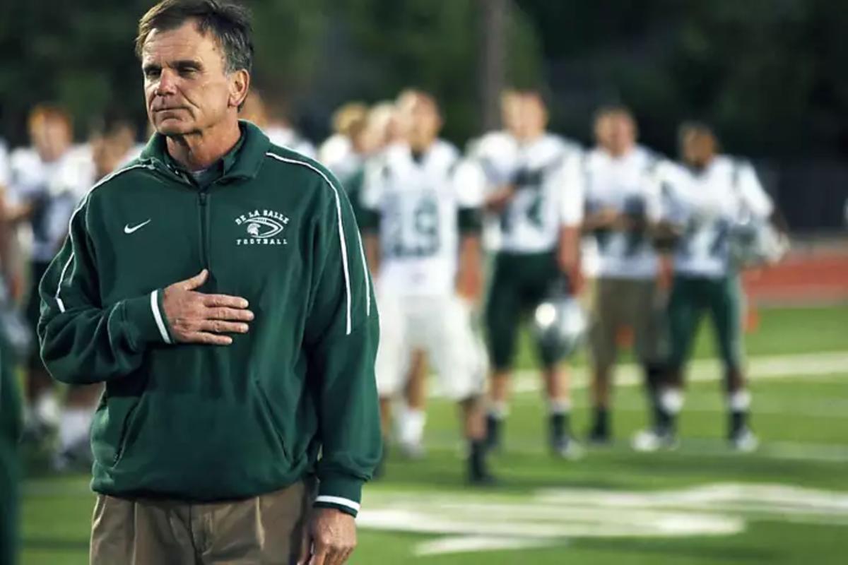 Bob Ladouceur head coach of De La Salle's nationally renowned football team stands with his players during the national anthem Friday October 7, 2011.