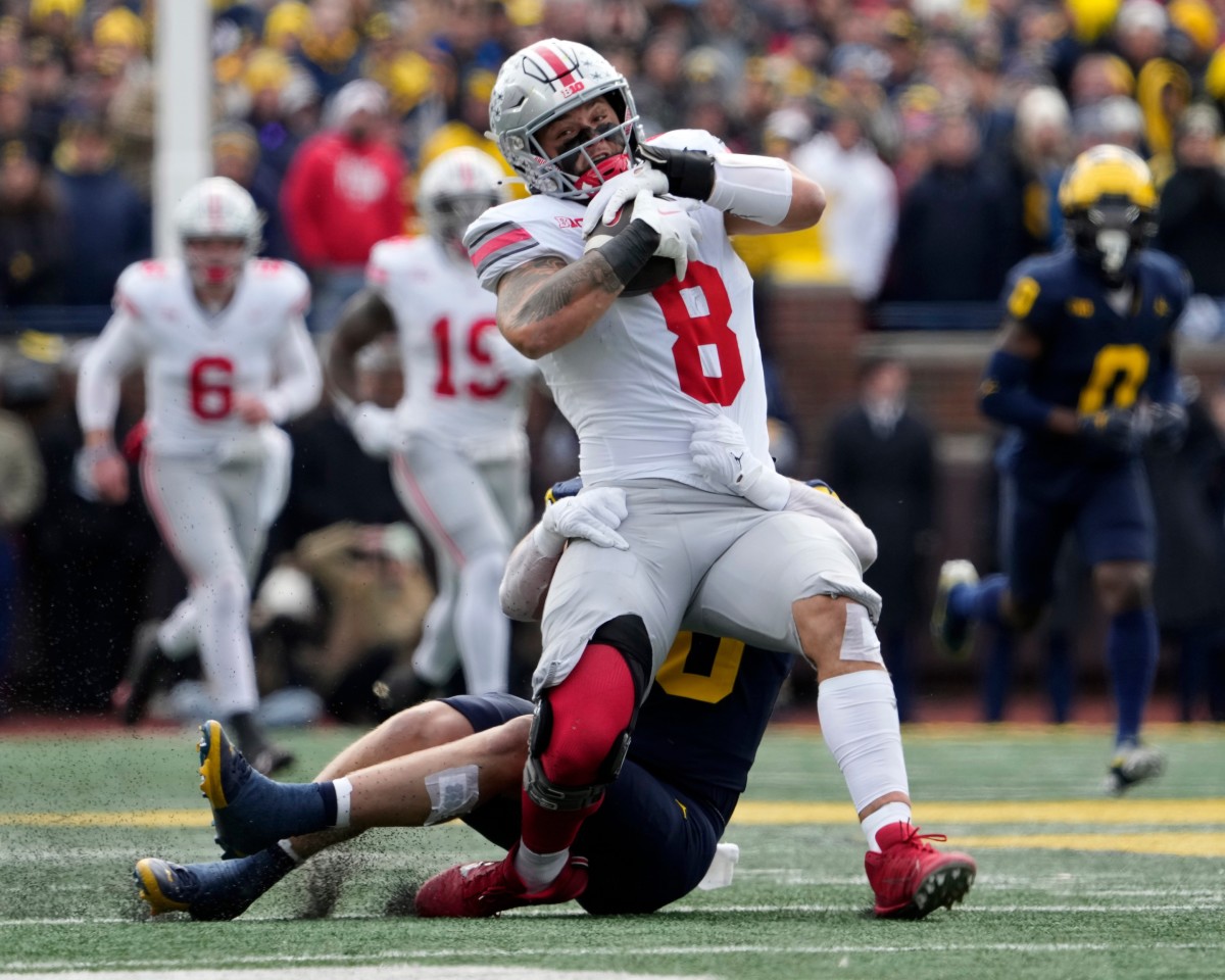 Nov. 25, 2023; Ann Arbor, Mi., USA; Ohio State Buckeyes tight end Cade Stover (8) is tackled by University of Michigan linebacker Jimmy Rolder (30) during the first half of Saturday s NCAA Division I football game at Michigan Stadium.  