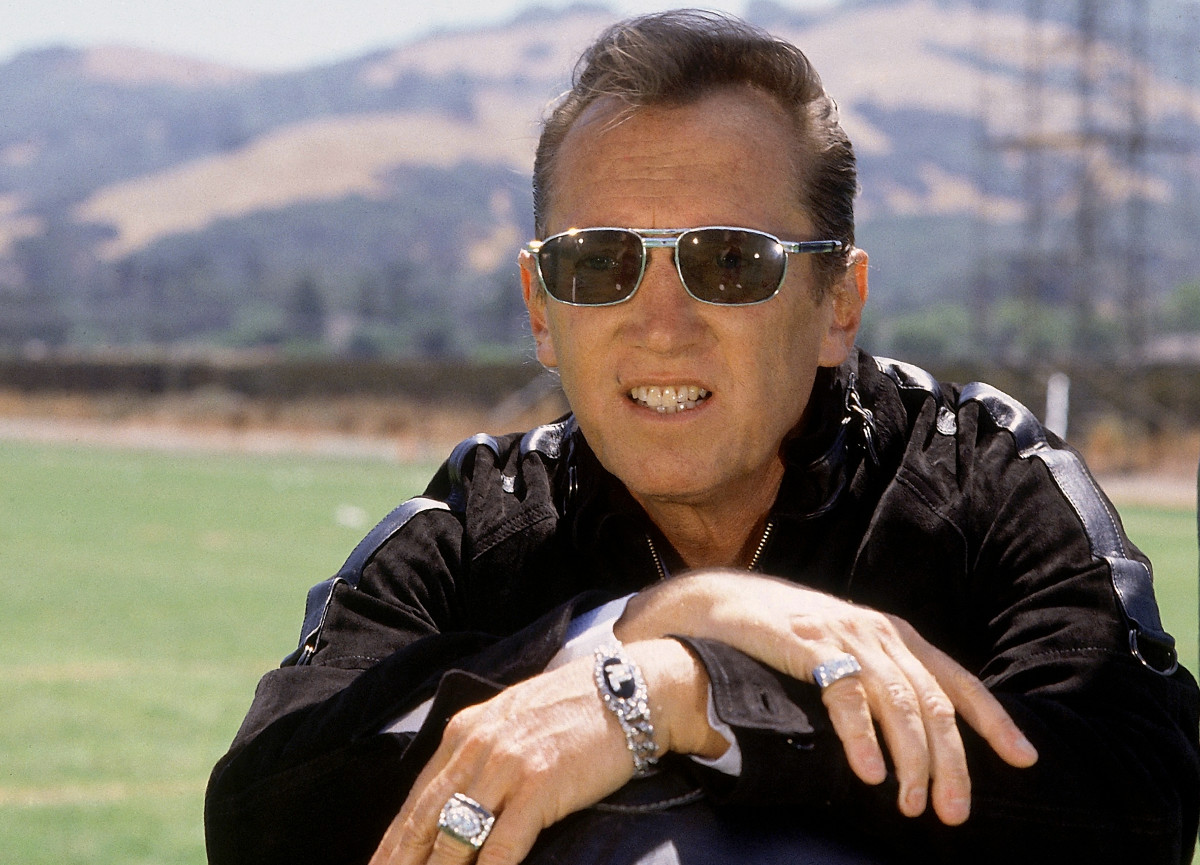 Los Angeles Raiders owner Al Davis poses with his hands crossed over each other and sunglasses on