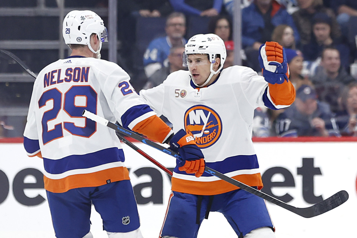 Feb 26, 2023; Winnipeg, Manitoba, CAN; New York Islanders center Brock Nelson (29) celebrates his second period goal with New York Islanders left wing Zach Parise (11) against the Winnipeg Jets at Canada Life Centre.