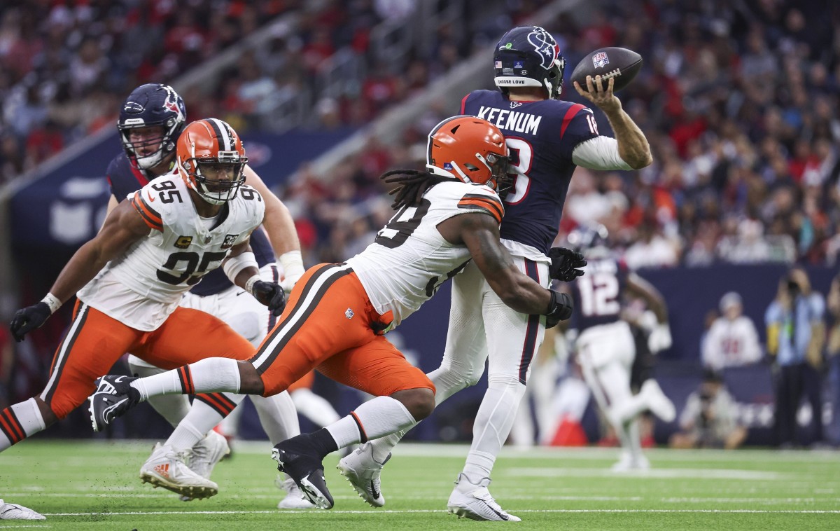 Dec 24, 2023; Houston, Texas, USA; Cleveland Browns defensive end Za'Darius Smith (99) attempts to tackle Houston Texans quarterback Case Keenum (18) during the game at NRG Stadium. Mandatory Credit: Troy Taormina-USA TODAY Sports