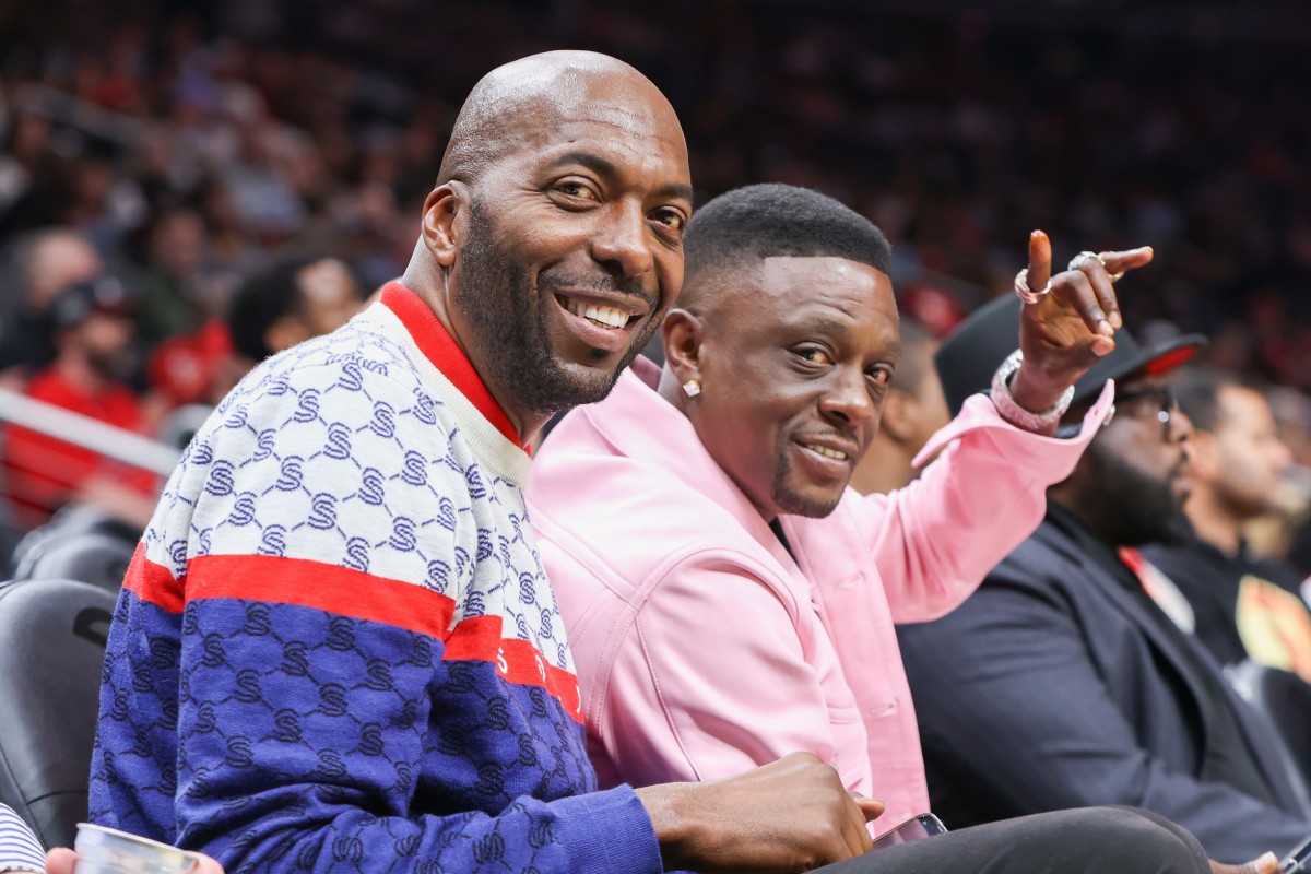 Former NBA player John Salley sits with rapper Boosie Badazz at a game between the Washington Wizards and Atlanta Hawks in the first half at State Farm Arena.
