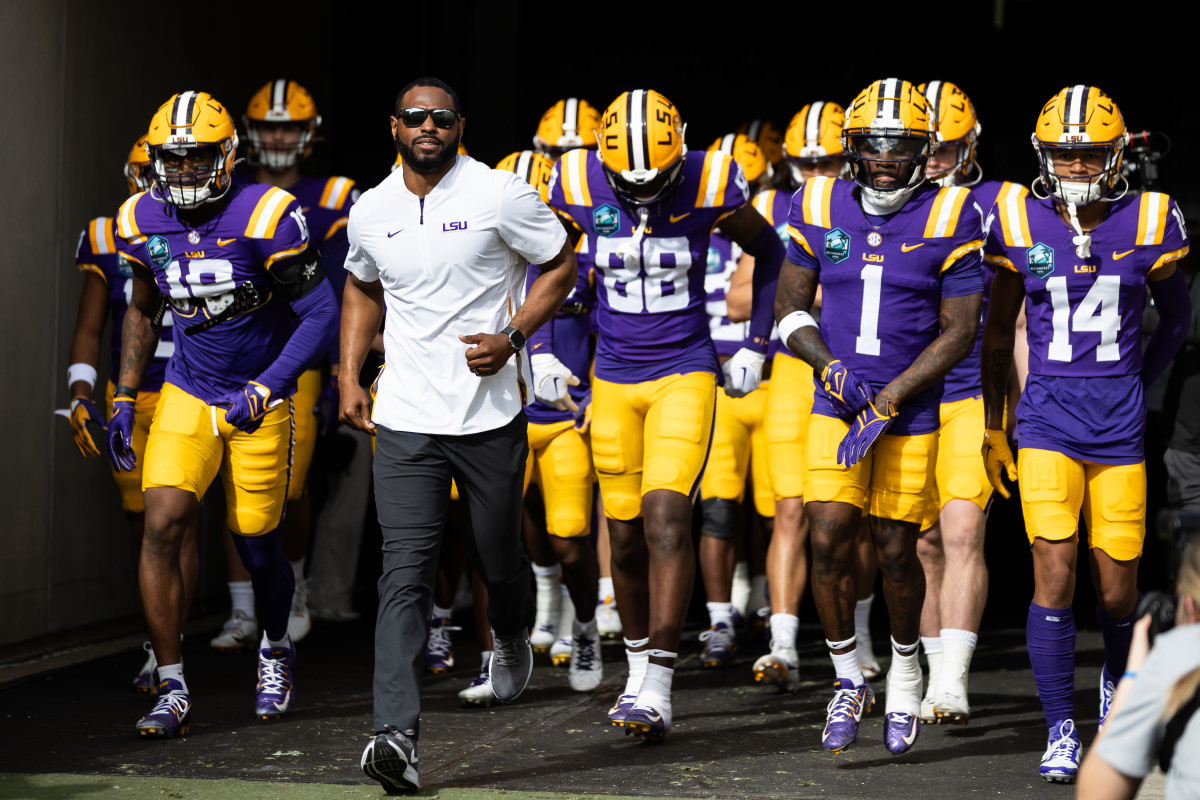Jan 1, 2024; Tampa, FL, USA; LSU Tigers wide receivers coach Cortez Hankton, tight end Ka'Morreun Pimpton (88), and wide receiver Aaron Anderson (1) run onto the field before the game against the Wisconsin Badgers at Raymond James Stadium. 