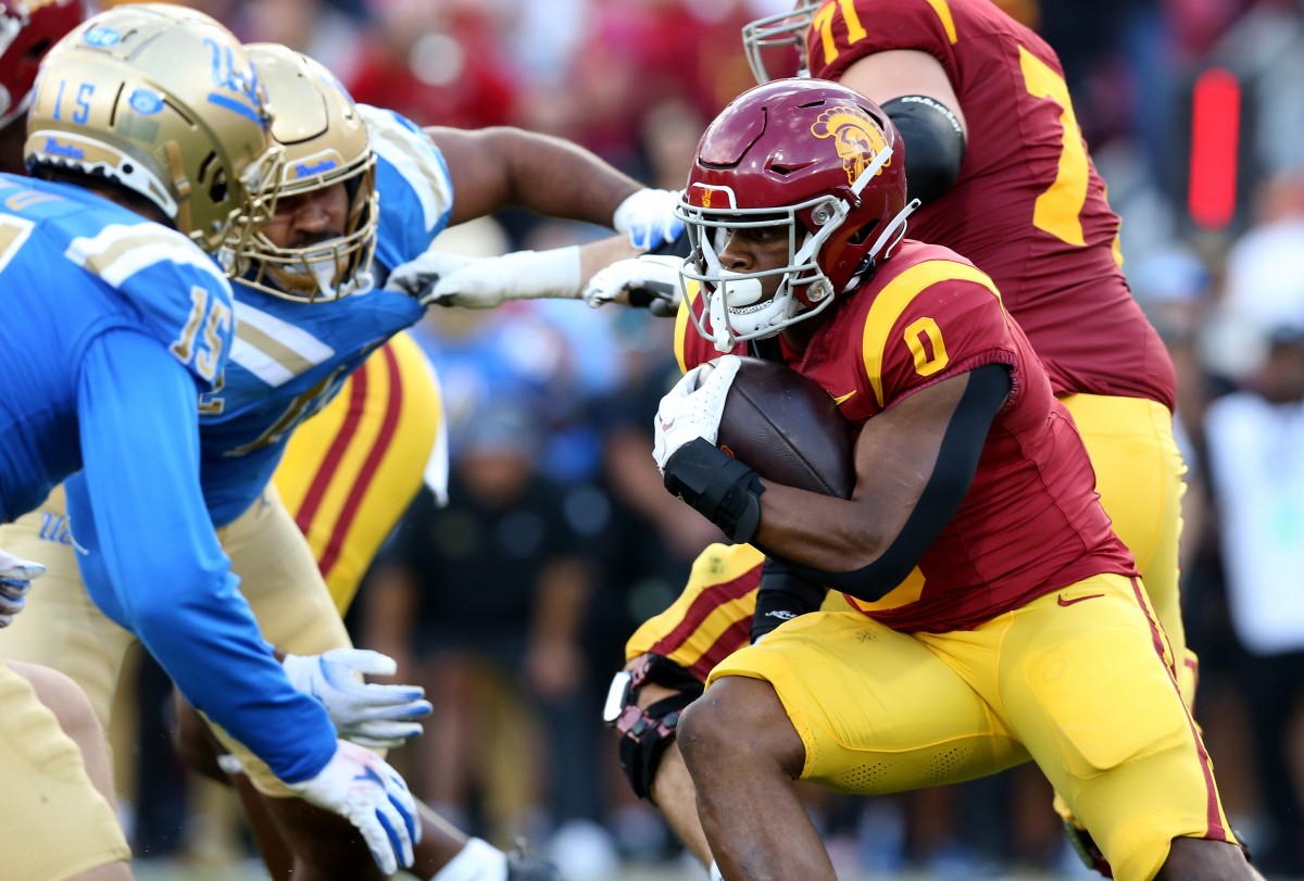 Nov 18, 2023; Los Angeles, California, USA; USC Trojans running back MarShawn Lloyd (0) runs during the first quarter against the UCLA Bruins at United Airlines Field at Los Angeles Memorial Coliseum. Mandatory Credit: Jason Parkhurst-USA TODAY Sports  