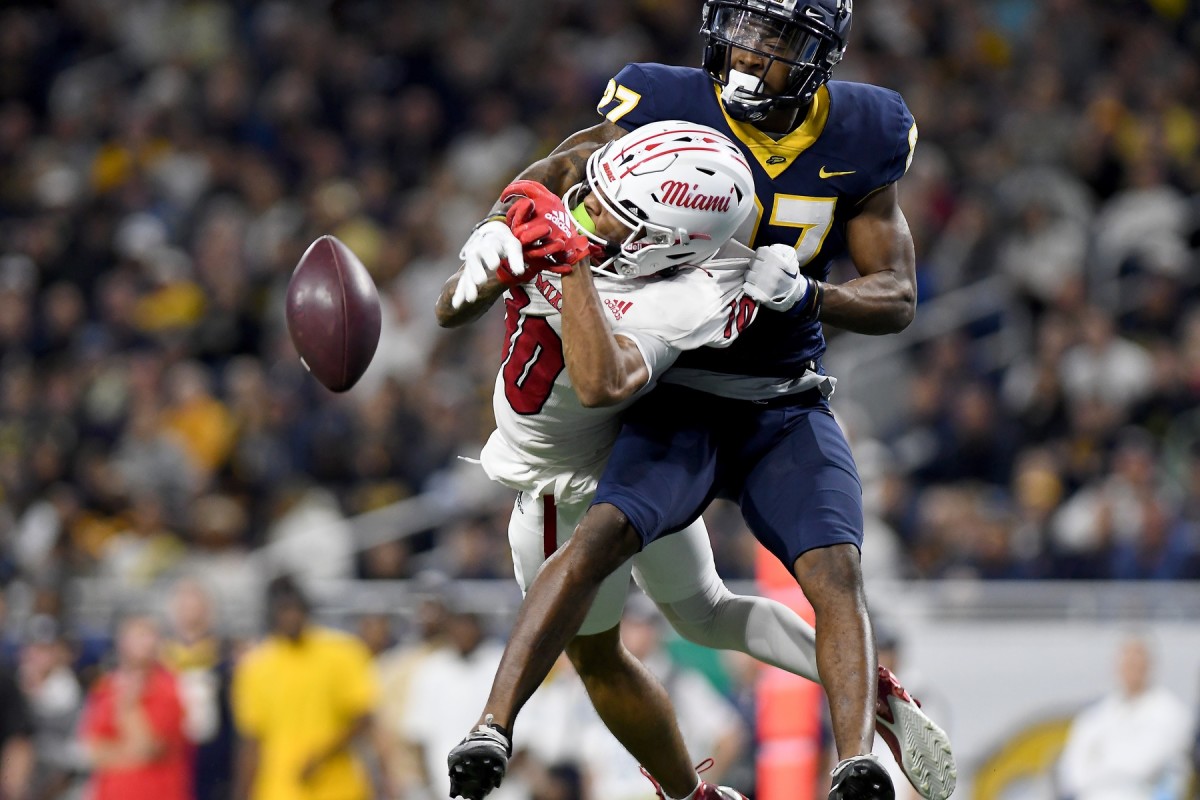 Dec 2, 2023; Detroit, MI, USA; Toledo Rockets cornerback Quinyon Mitchell (27) breaks up a pass intended for Miami (OH) Redhawks wide receiver Gage Larvadain (10) in the third quarter at Ford Field. Mandatory Credit: Lon Horwedel-USA TODAY Sports  