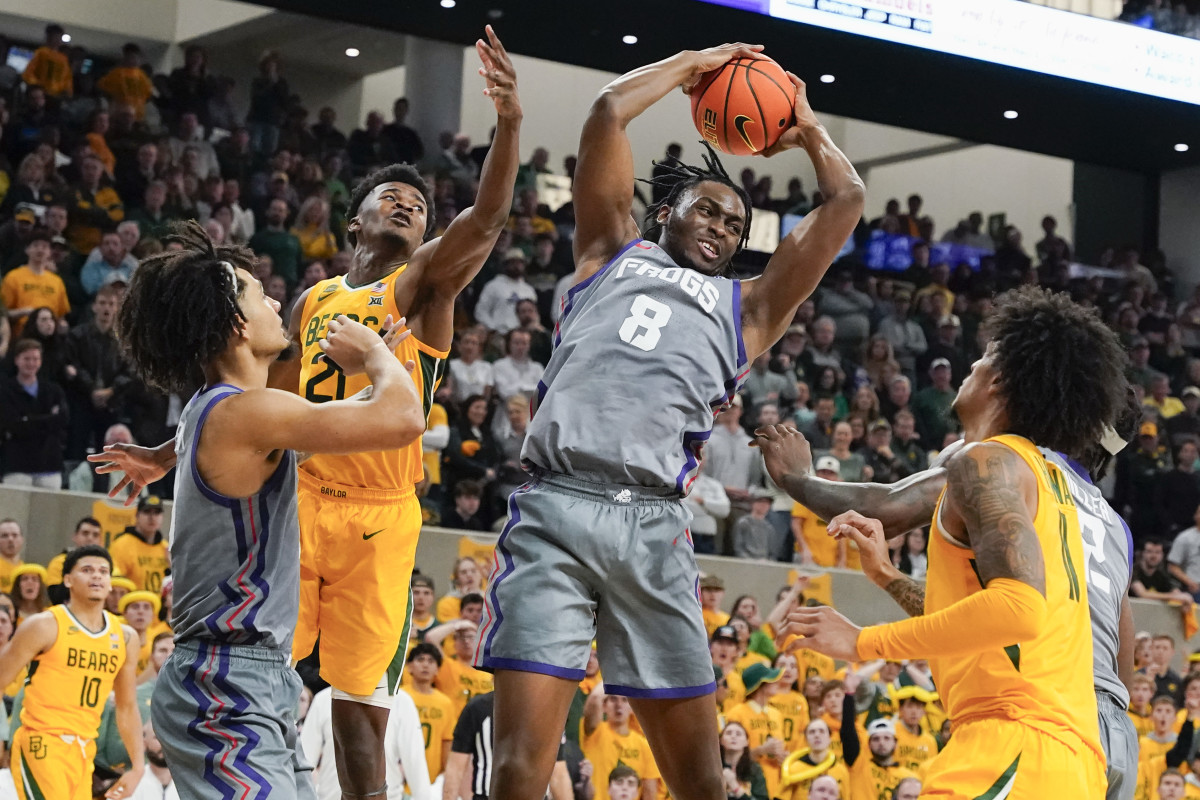 Jan 27, 2024; Waco, Texas, USA; TCU Horned Frogs center Ernest Udeh Jr. (8) grabs the rebound against the Baylor Bears during the second half at Paul and Alejandra Foster Pavilion. Mandatory Credit: Raymond Carlin III-USA TODAY Sports  