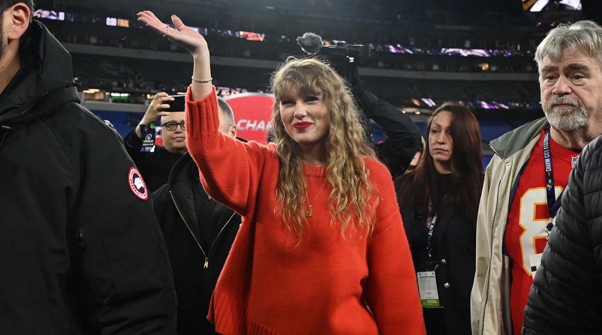 Taylor Swift walks on the field after the Chiefs won the AFC championship.