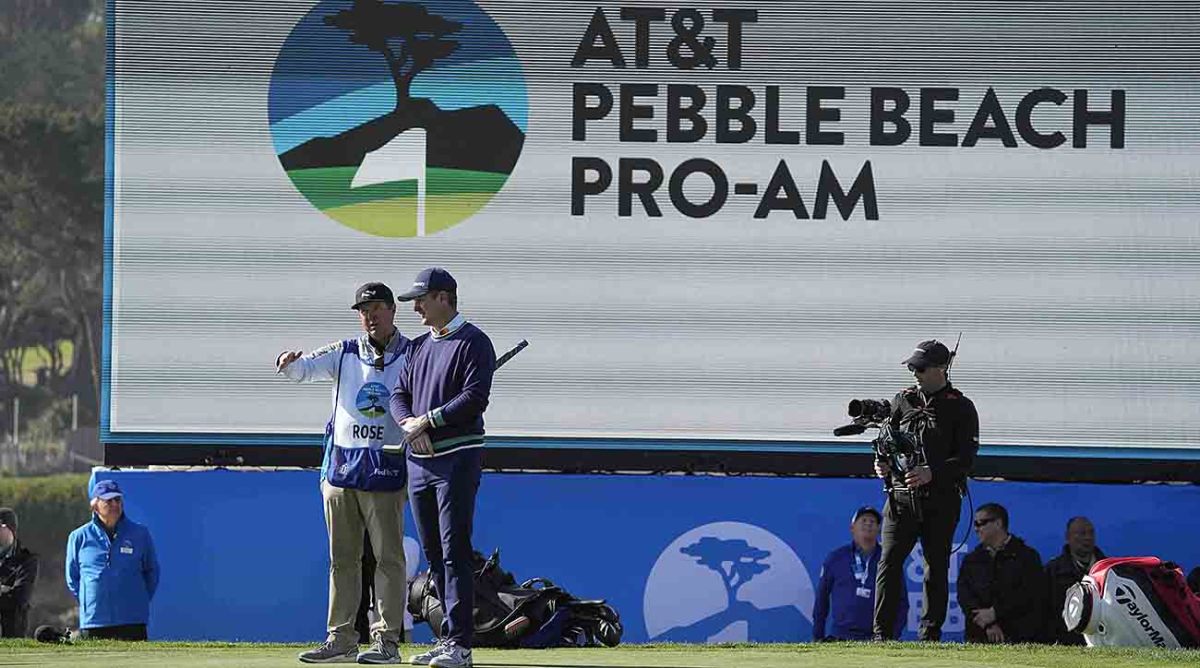 Justin Rose (right) talks to his caddie at the 2023 AT&T Pebble Beach Pro-Am at Pebble Beach Golf Links.