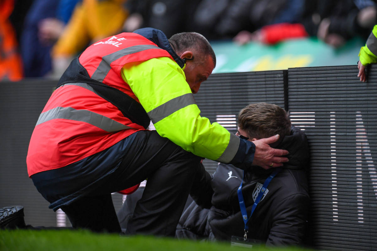 A West Brom ball boy pictured receiving attention from a steward after being hit by an object thrown from the crowd during an FA Cup game against Wolves in January 2024