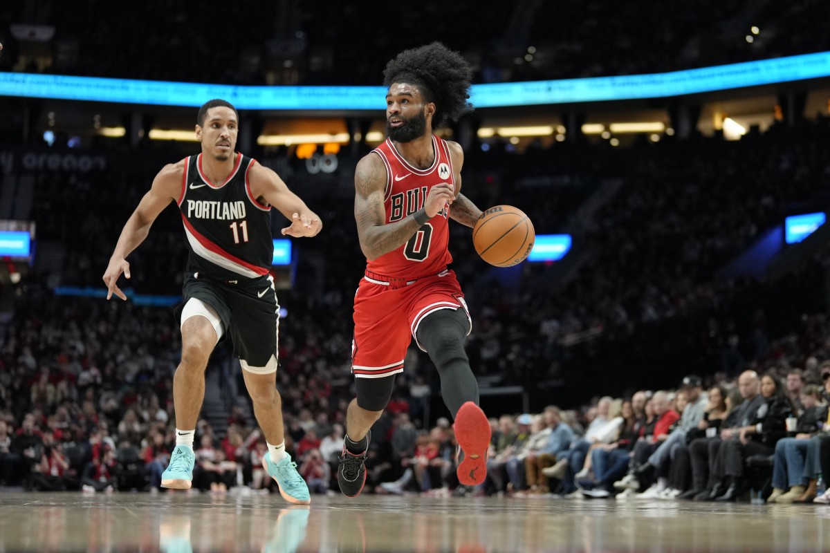 Chicago Bulls point guard Coby White (0) dribbles the ball while defended by Portland Trail Blazers point guard Malcolm Brogdon (11) during the first half at Moda Center.