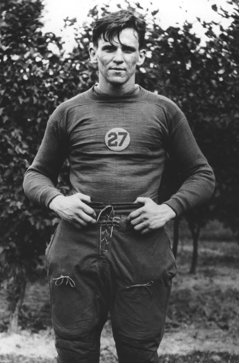 Johnny "Blood" McNally looks ahead with his hands on his waistband