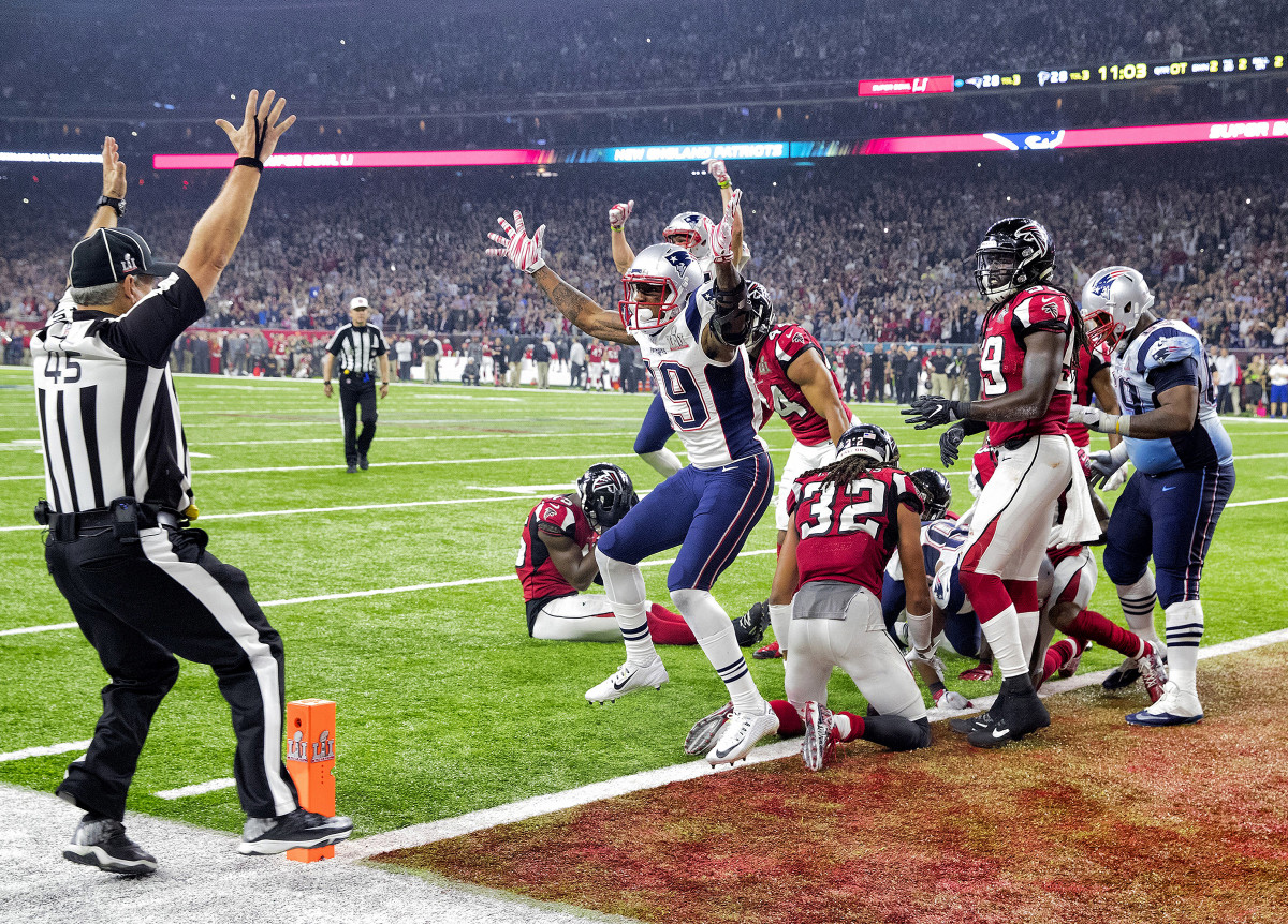 Malcolm Mitchell throws his hands up in celebration, mimicking line ref Jeff Seeman signaling the touchdown