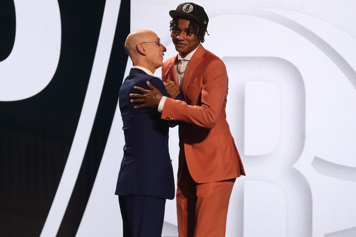 Dariq Whitehead (Duke) is greeted by NBA commissioner Adam Silver after being selected twenty-second by the Brooklyn Nets