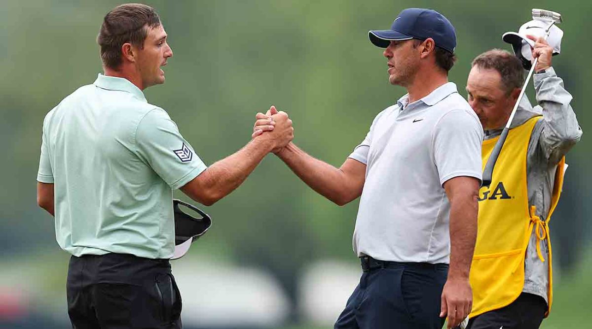Brooks Koepka and Bryson DeChambeau shake hands on the 18th hole after the third round of the 2023 PGA Championship at Oak Hill Country Club in Rochester, N.Y.