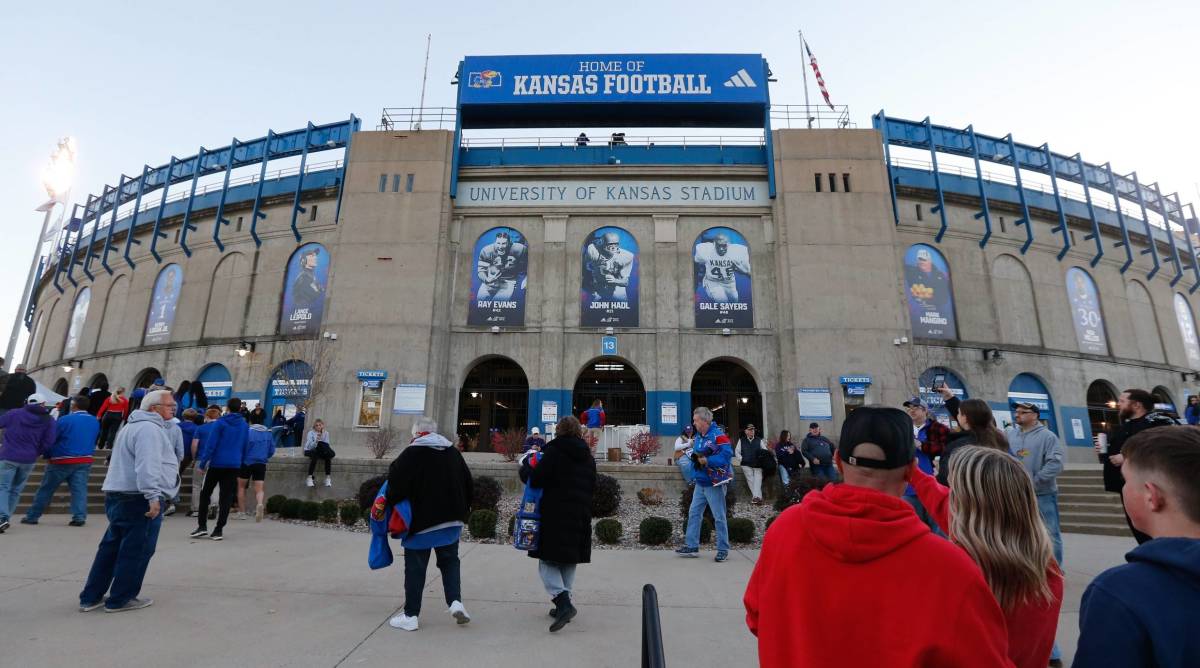 Fans walk into David Booth Kansas Memorial Stadium before a game.