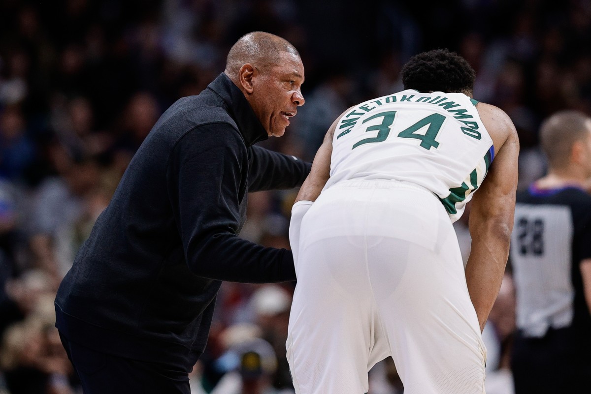 Milwaukee Bucks head coach Doc Rivers talks with forward Giannis Antetokounmpo (34) in the fourth quarter against the Denver Nuggets